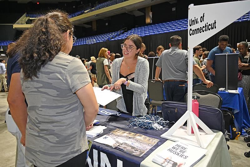 Alexandra Fragola, admissions officer for the University of Connecticut, speaks with prospective students and parents.